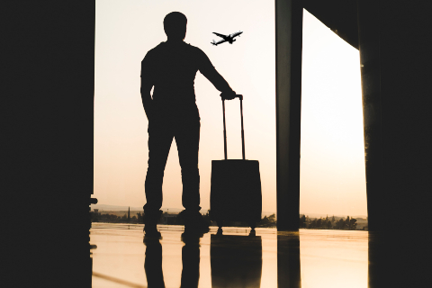 man in airport with luggage